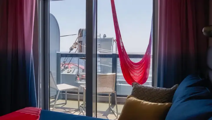 Cabina balcone vista parziale MSC con amaca rossa e cuscini accoglienti.